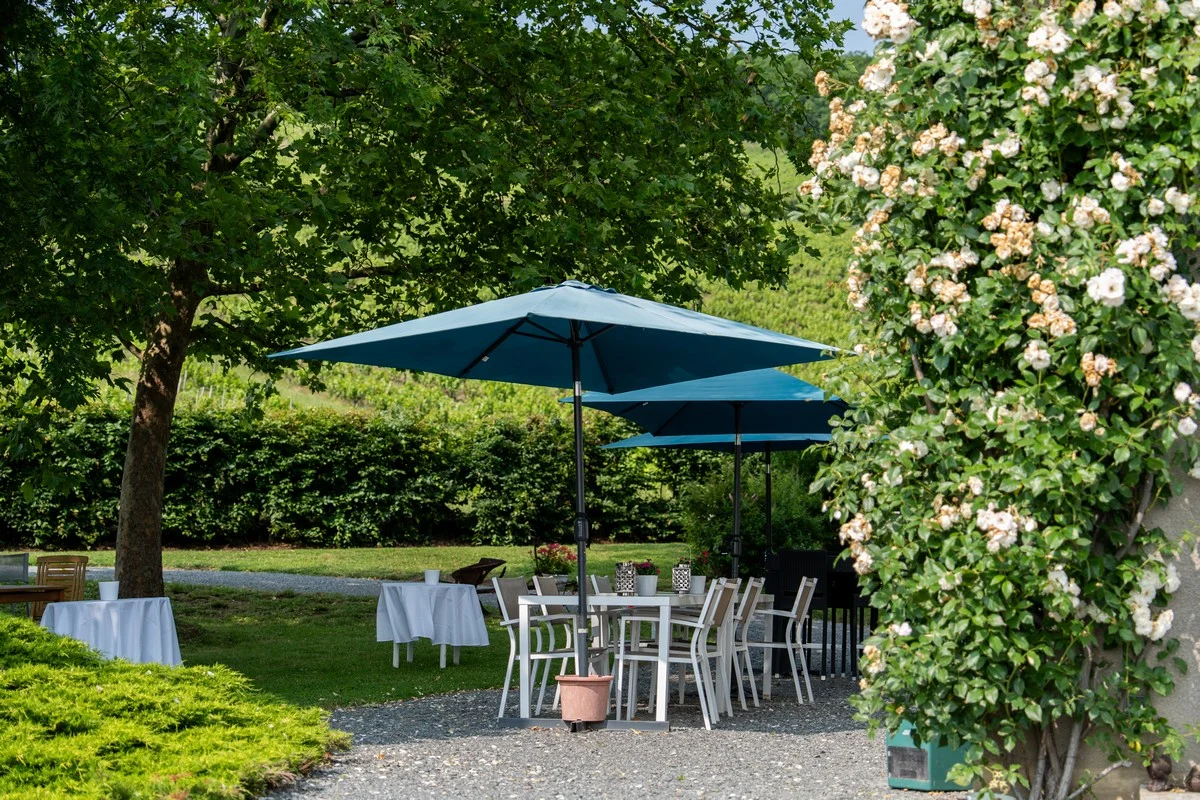 Coin salon extérieur fleuri sous les parasols