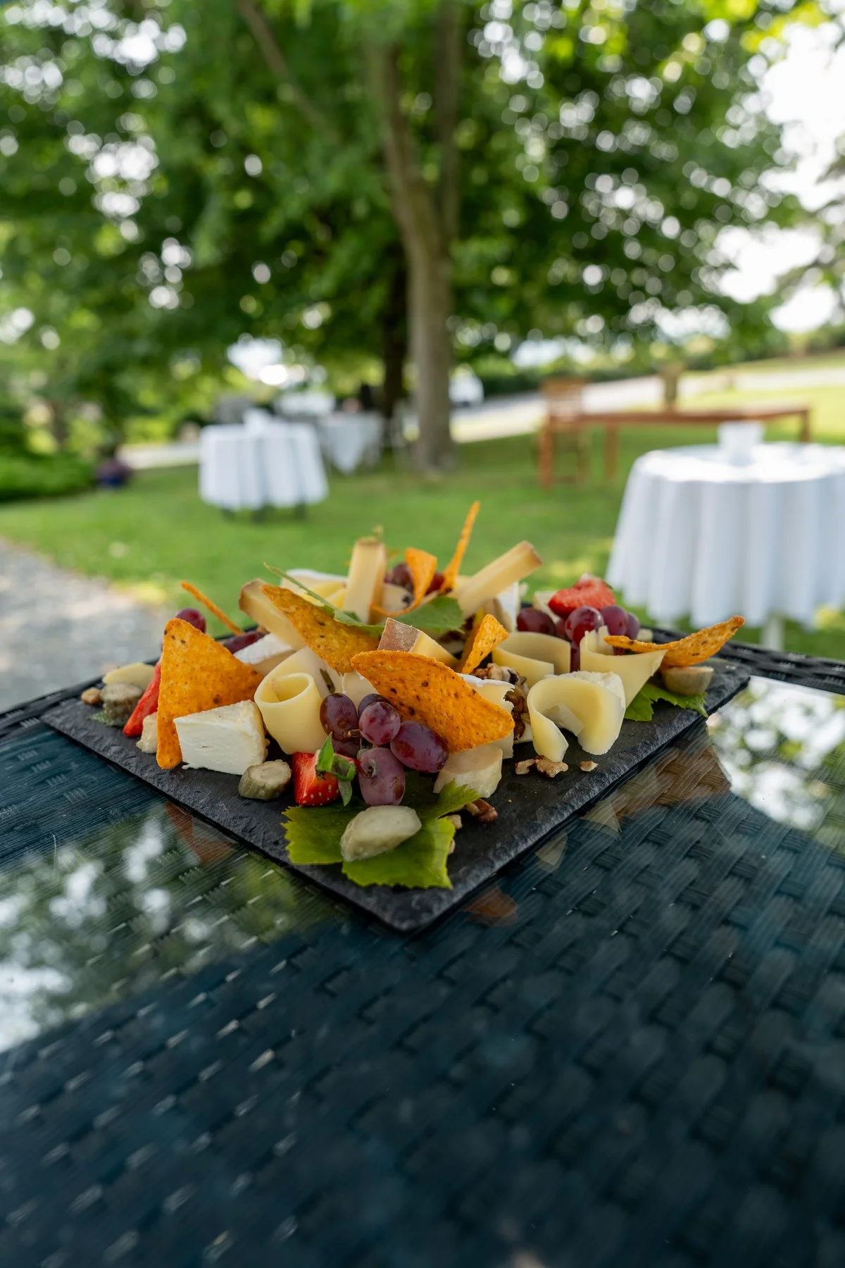 Beautifully arranged plate of cheeses and fruit — close-up